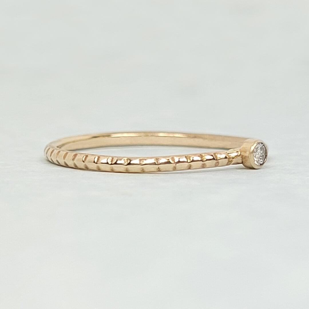 Tiny diamond ring with textured band in 14kt gold