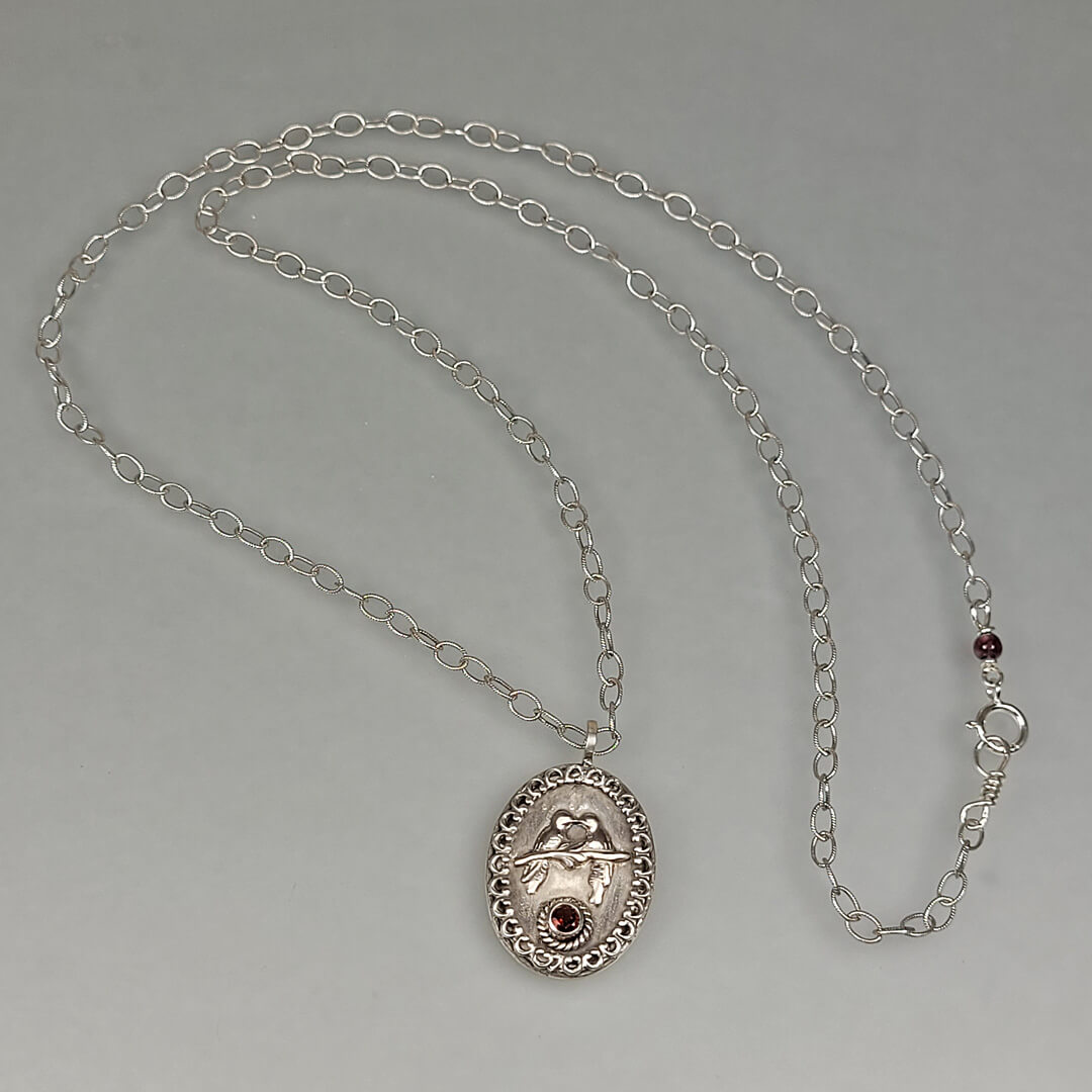 sterling silver love birds necklace with garnet