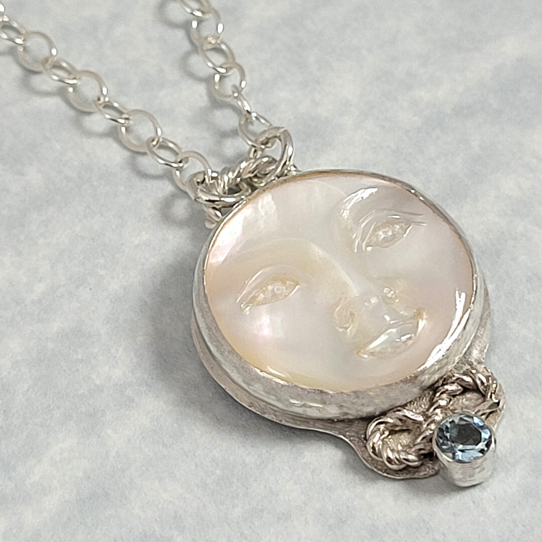 mother of pearl moon face necklace with aquamarine in sterling silver