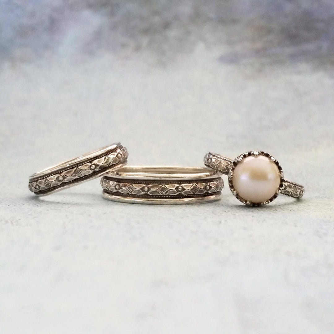Edwardian-inspired vintage style pearl engagement ring and matching women's wedding band