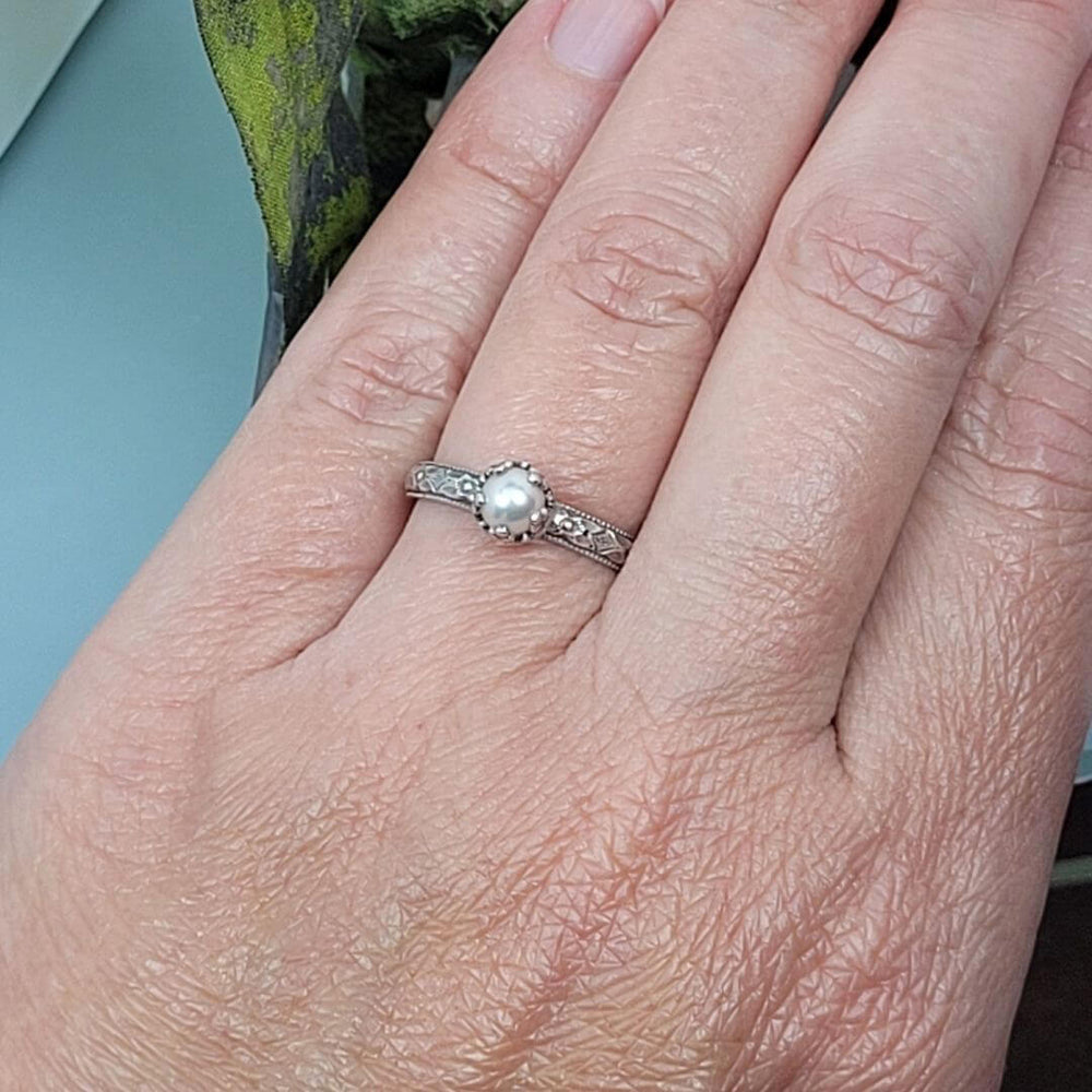 Edwardian vintage-inspired petite pearl engagement ring in sterling silver on model