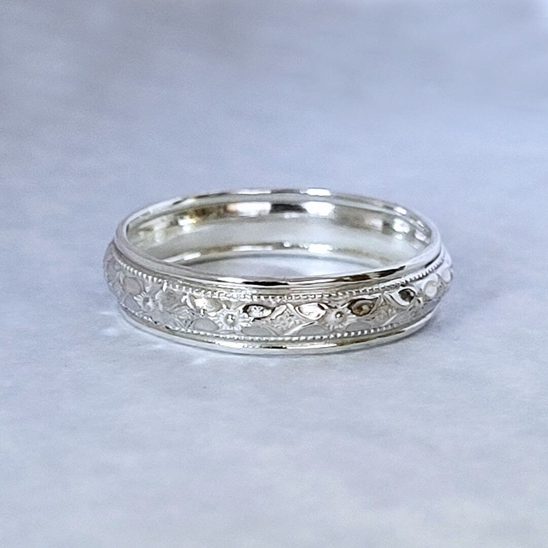 Vintage style classic women's wedding band in sterling silver with floral textured band
