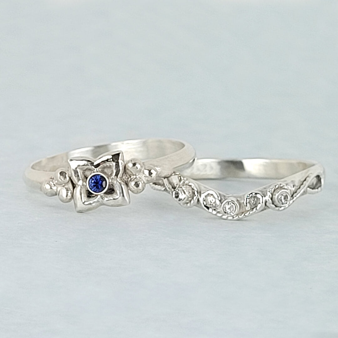 Art Deco-inspired Blue Sapphire Engagement Ring and Edwardian-inspired Scrollwork White Sapphire Curved Wedding Band in Sterling Silver
