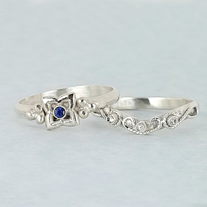 Art Deco-inspired Blue Sapphire Engagement Ring and Edwardian-inspired Scrollwork White Sapphire Curved Wedding Band in Sterling Silver