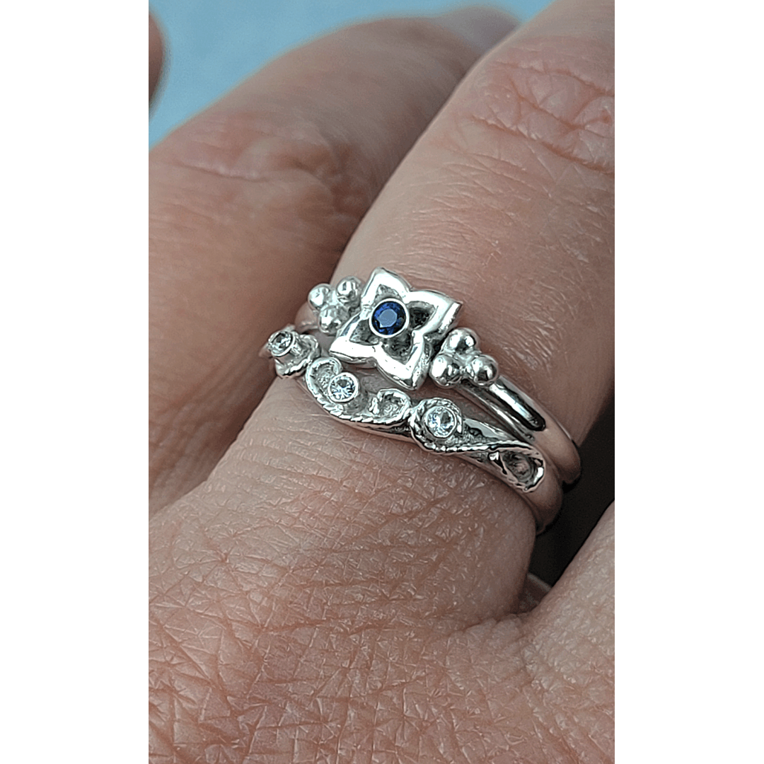 Art Deco-inspired Blue Sapphire Engagement Ring and Edwardian-inspired Scrollwork White Sapphire Curved Wedding Band in Sterling Silver