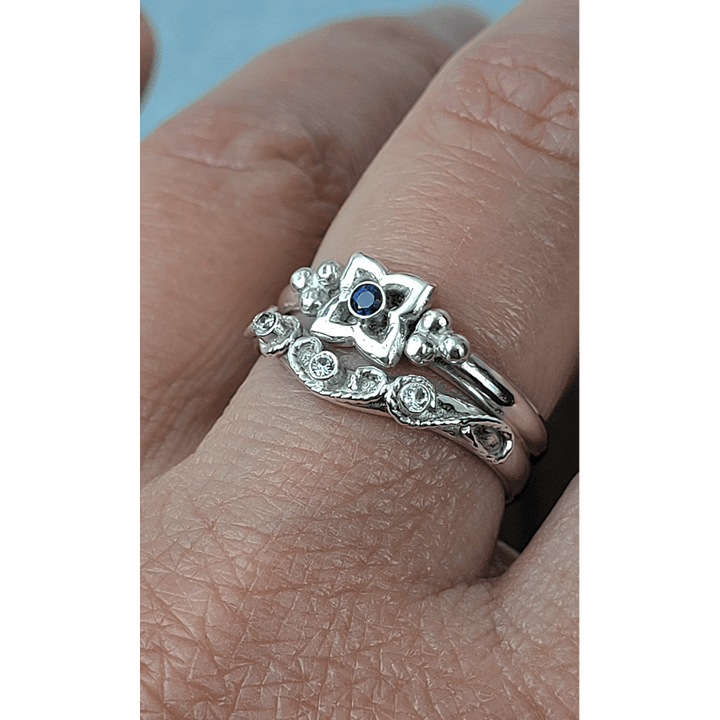 Art Deco-inspired Blue Sapphire Engagement Ring and Edwardian-inspired Scrollwork White Sapphire Curved Wedding Band in Sterling Silver