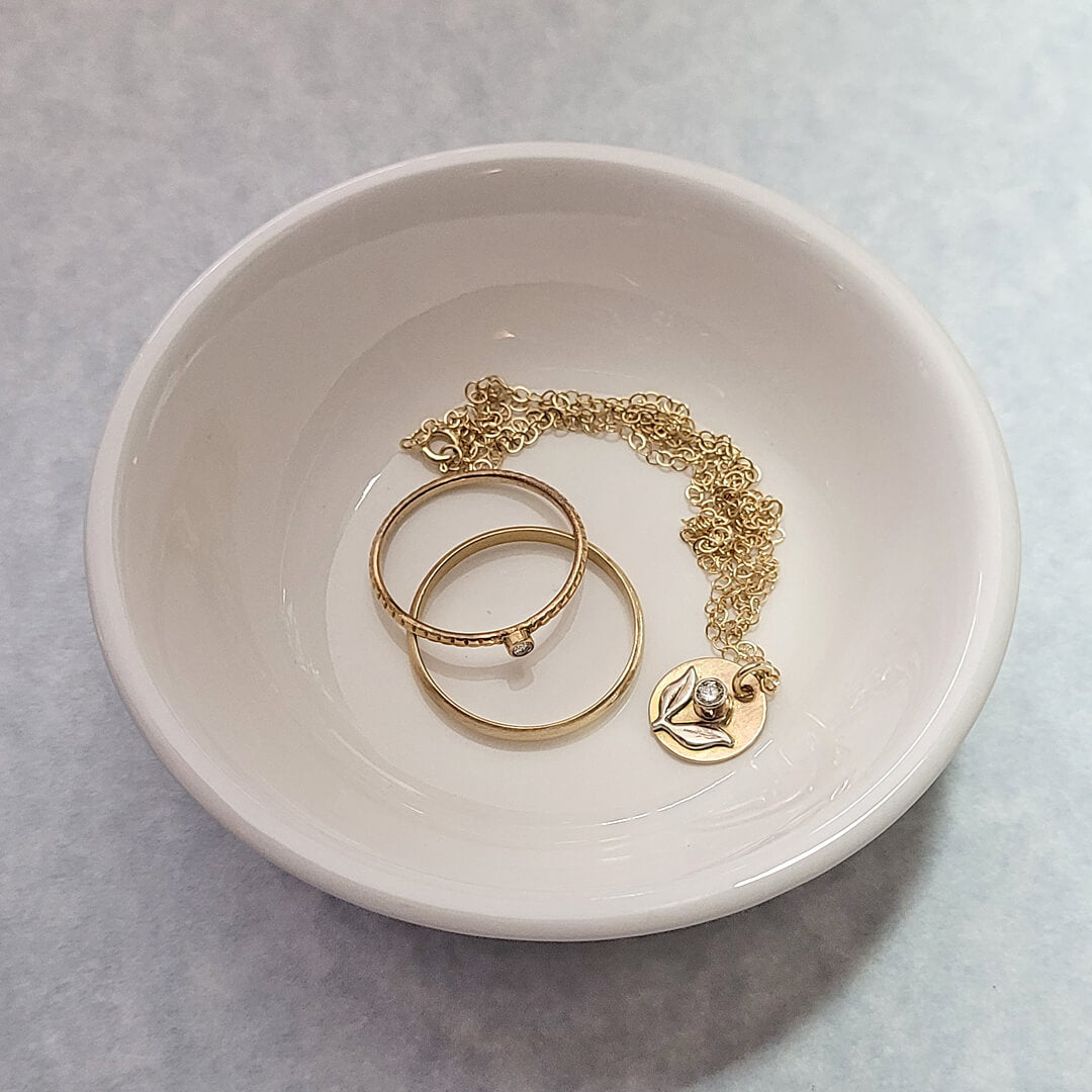 solid gold jewelry in bowl