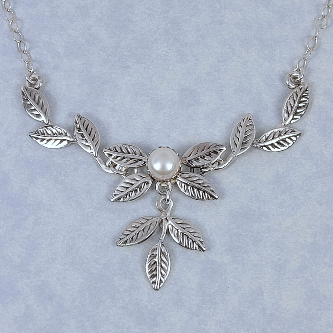 Handmade sterling silver vine and leaf necklace featuring a cultured freshwater pearl