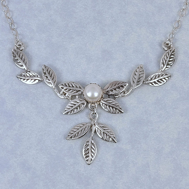 Handmade sterling silver vine and leaf necklace featuring a cultured freshwater pearl