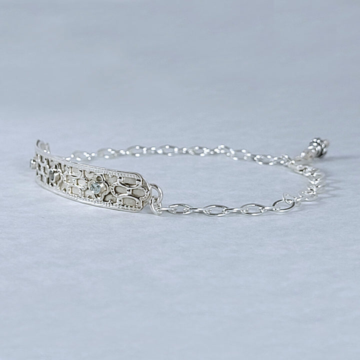 Close up of side detail of Art deco inspired geometric bar bracelet in sterling silver set with blue topaz 