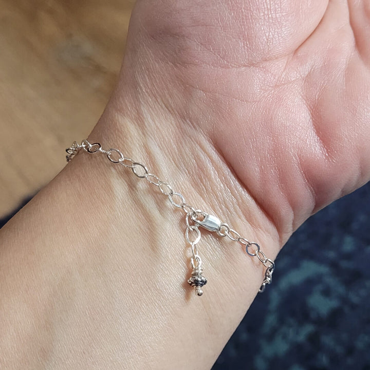 adjustable back of sterling silver  bar bracelet on wrist