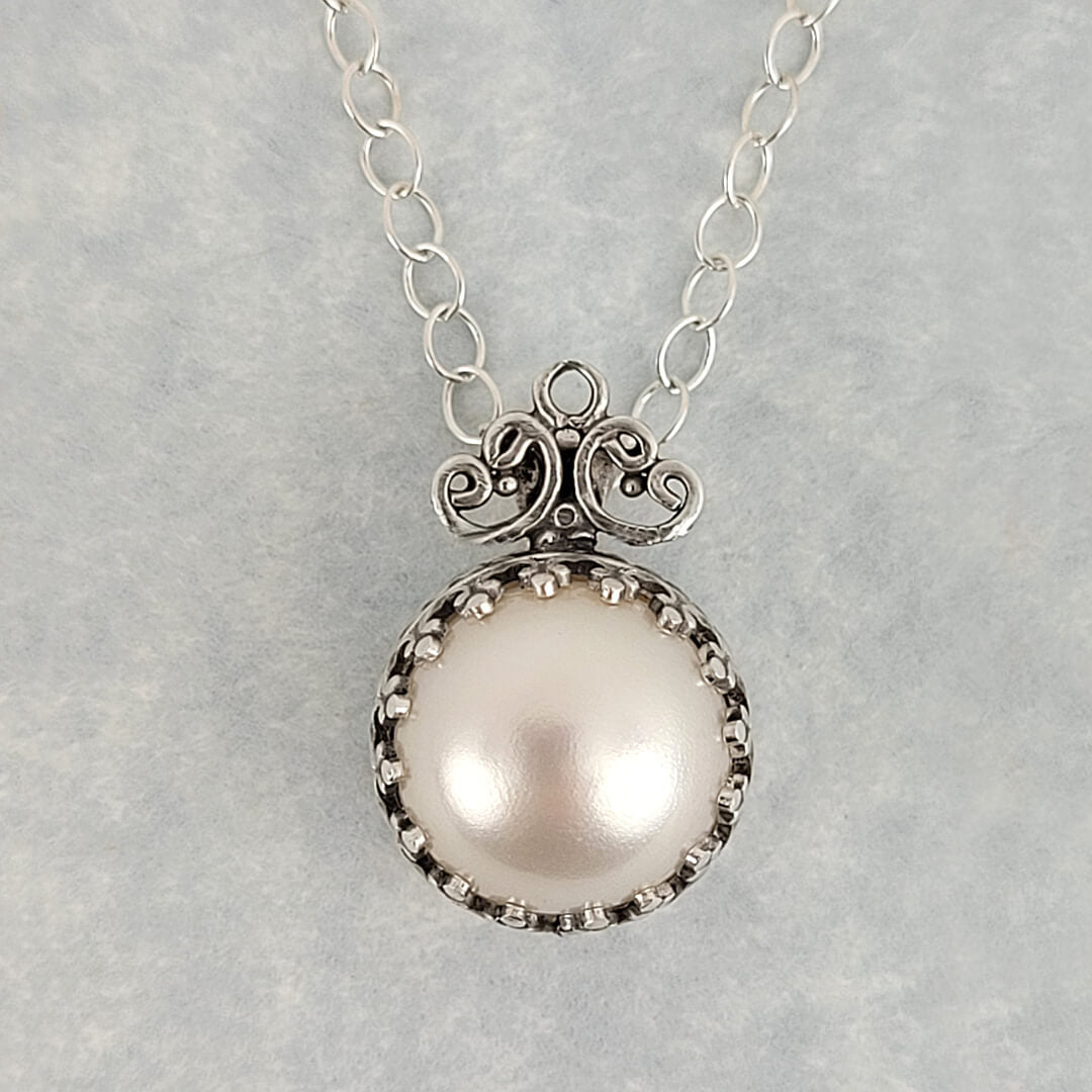 vintage style pearl pendant necklace with filigree detail in sterling silver