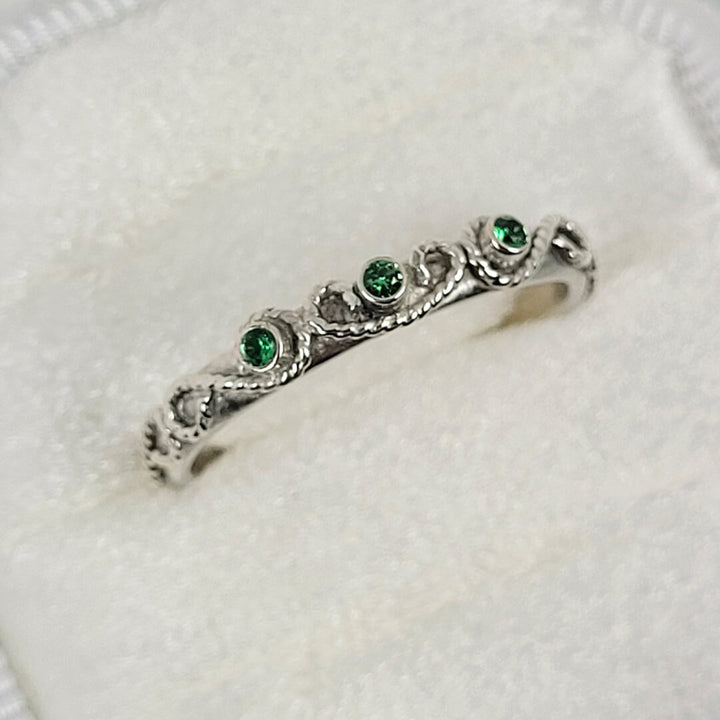 vintage-inspired scrollwork ring with emeralds in sterling silver