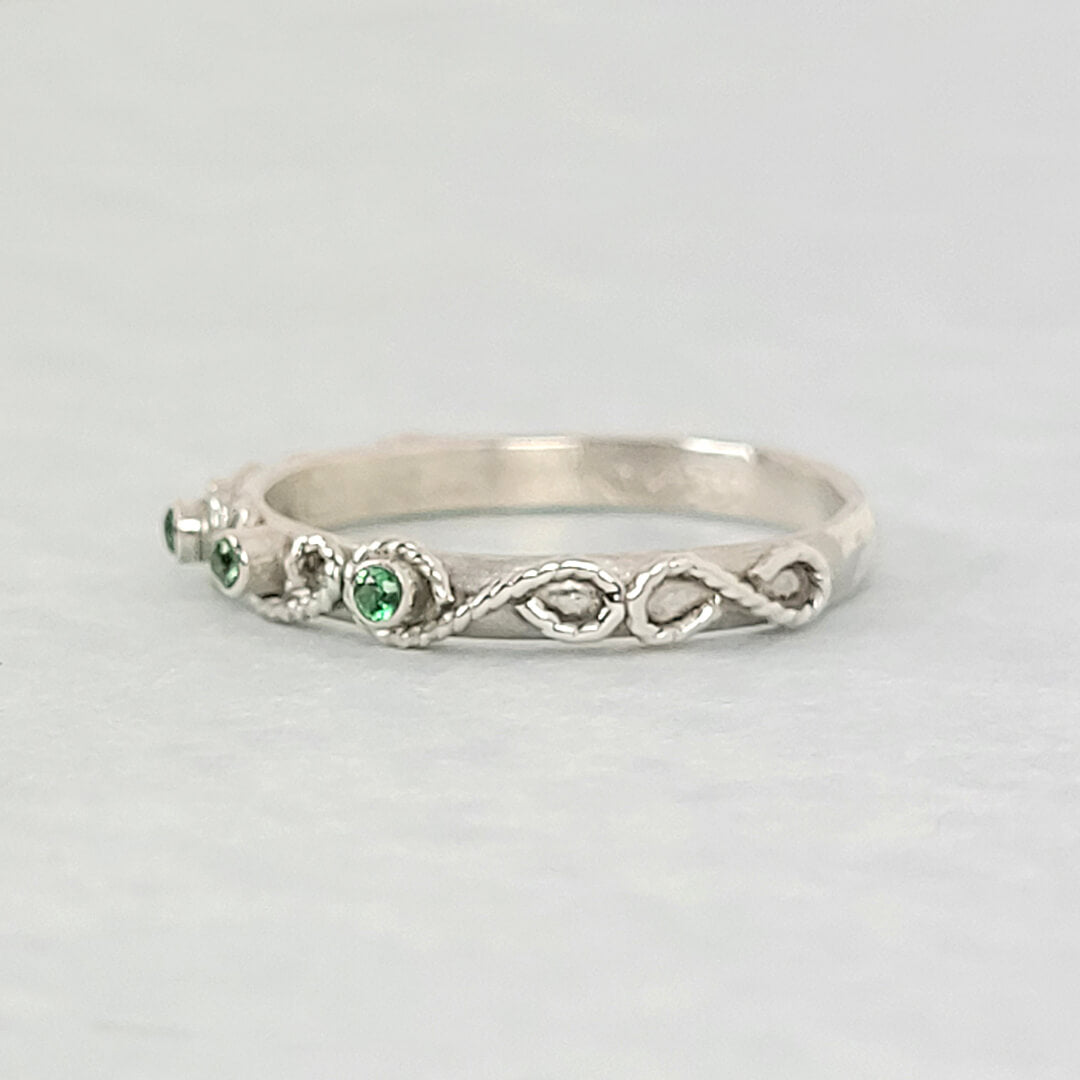 vintage-inspired scrollwork ring with emeralds in sterling silver