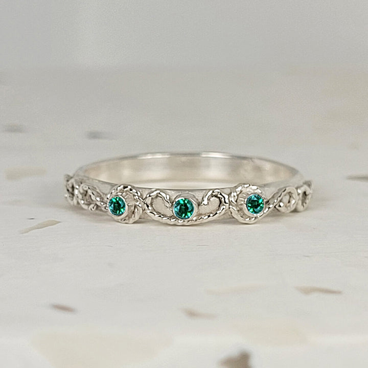 vintage-inspired scrollwork ring with emeralds in sterling silver
