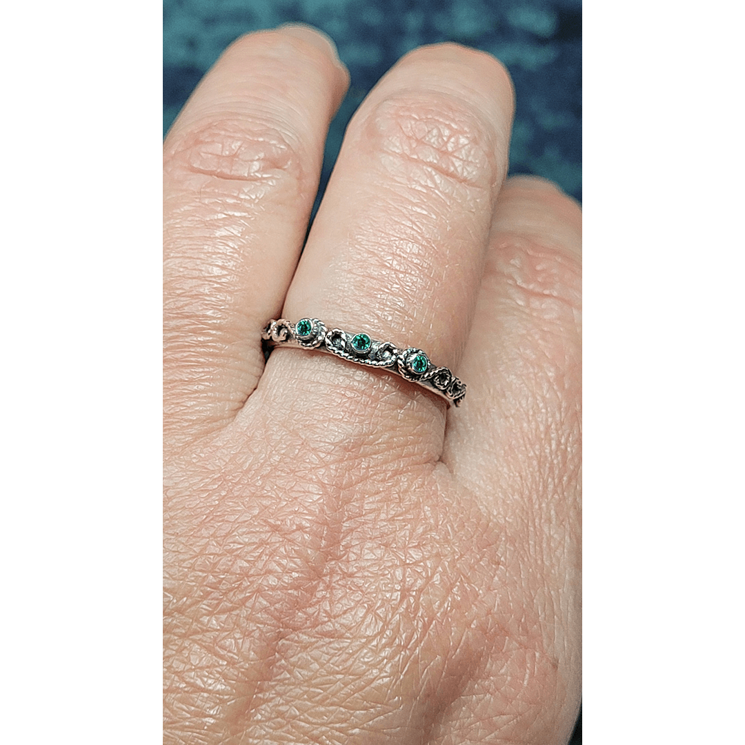 vintage-inspired scrollwork ring with emeralds in oxidized sterling silver