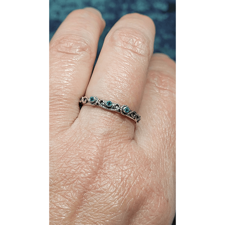 vintage-inspired scrollwork ring with emeralds in oxidized sterling silver