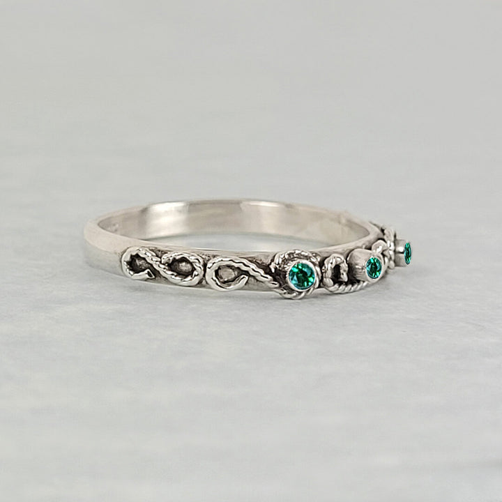 vintage-inspired scrollwork ring with emeralds in oxidized sterling silver