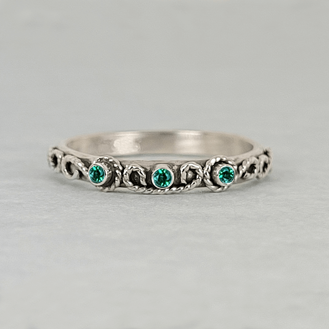 vintage-inspired scrollwork ring with emeralds in oxidized sterling silver