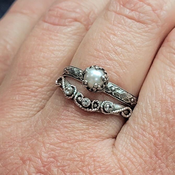 vintage style pearl engagement ring and scrollwork curved wedding band with white sapphires set in sterling silver