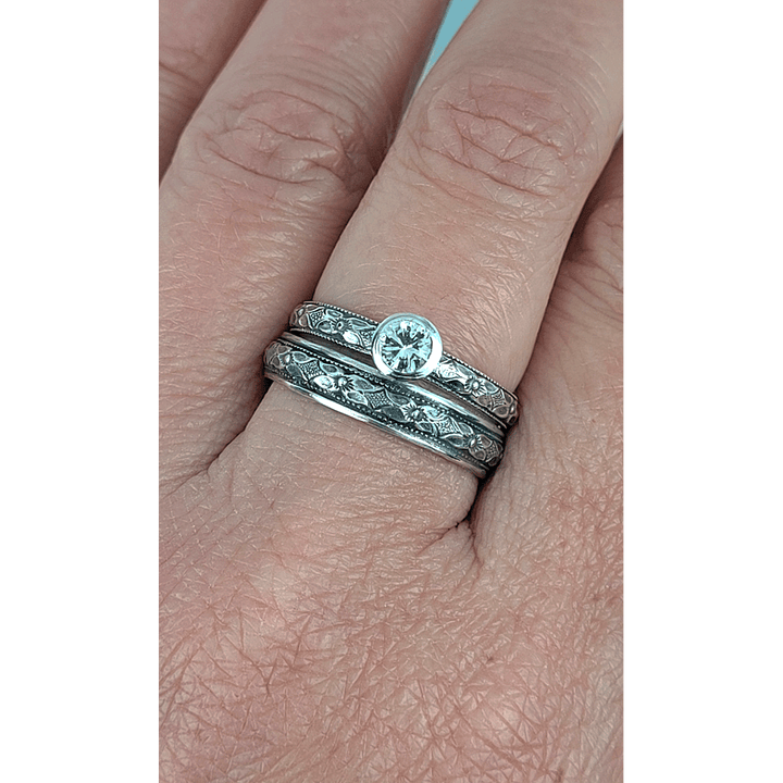 Vintage style white sapphire engagement ring and matching wedding band in sterling silver on model