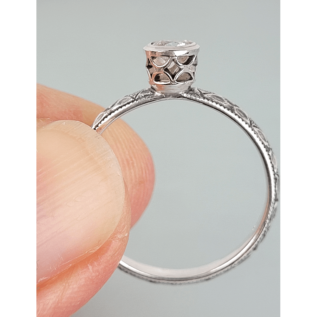 Vintage style white sapphire engagement ring with pierced bezel setting in sterling silver side view