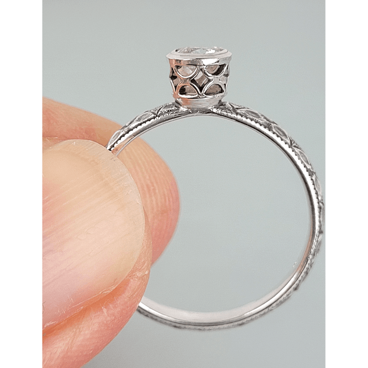 Vintage style white sapphire engagement ring with pierced bezel setting in sterling silver side view