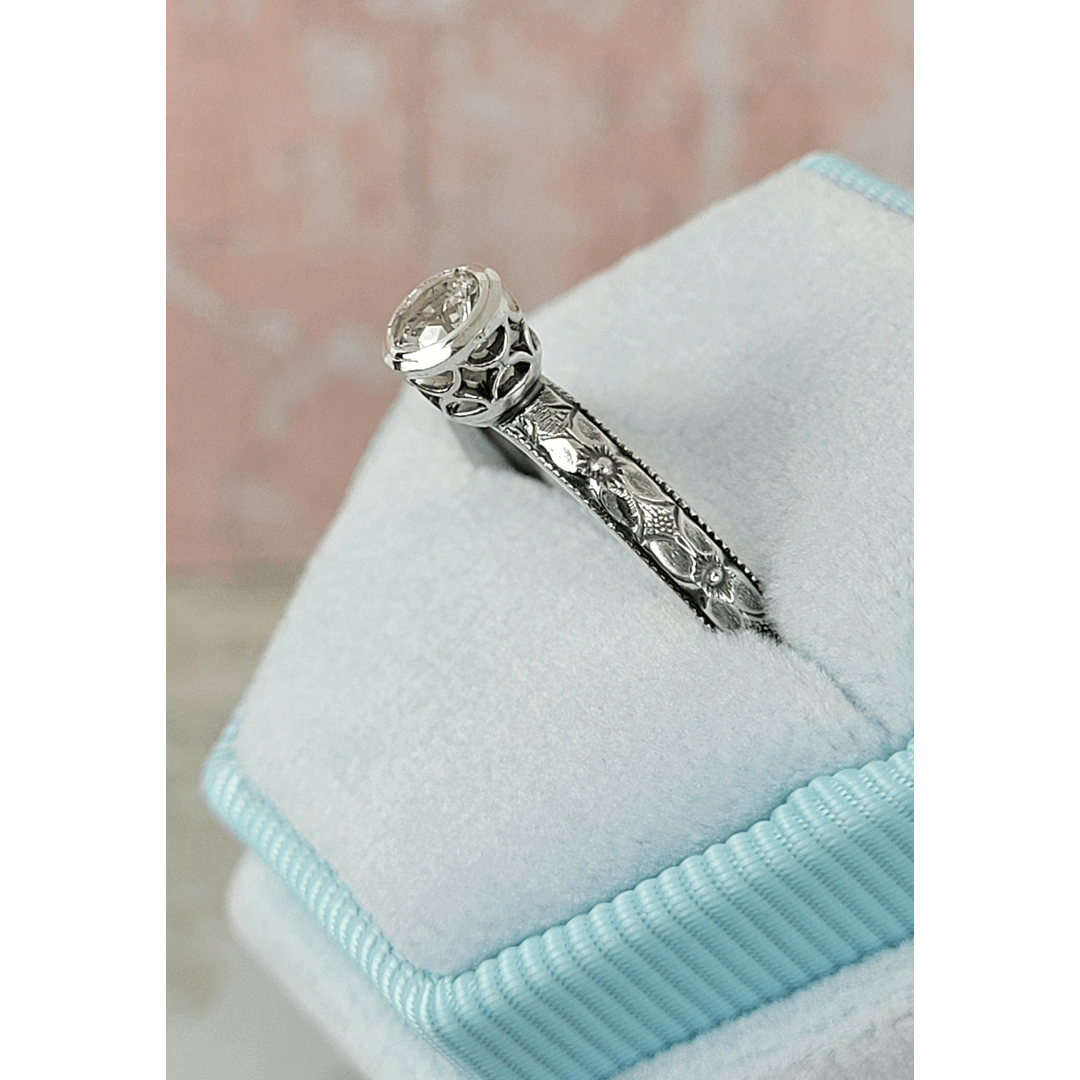 Vintage style white sapphire engagement ring with pierced bezel setting in sterling silver in velvet box