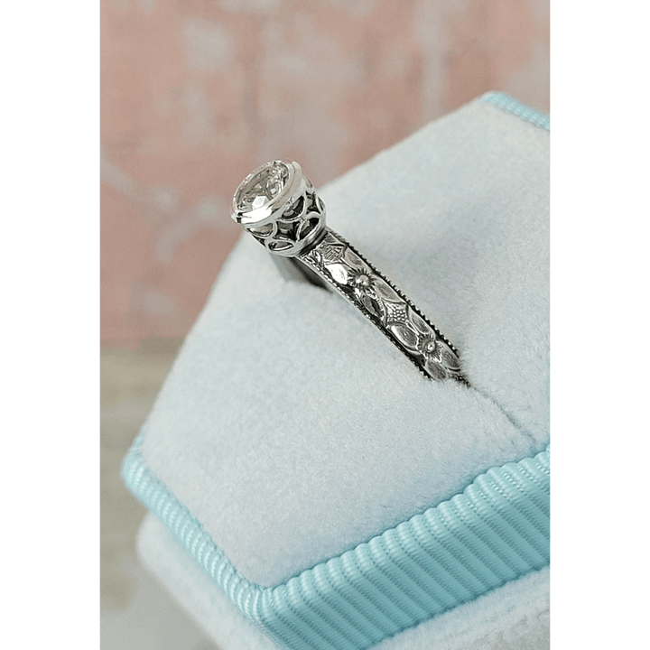 Vintage style white sapphire engagement ring with pierced bezel setting in sterling silver in velvet box