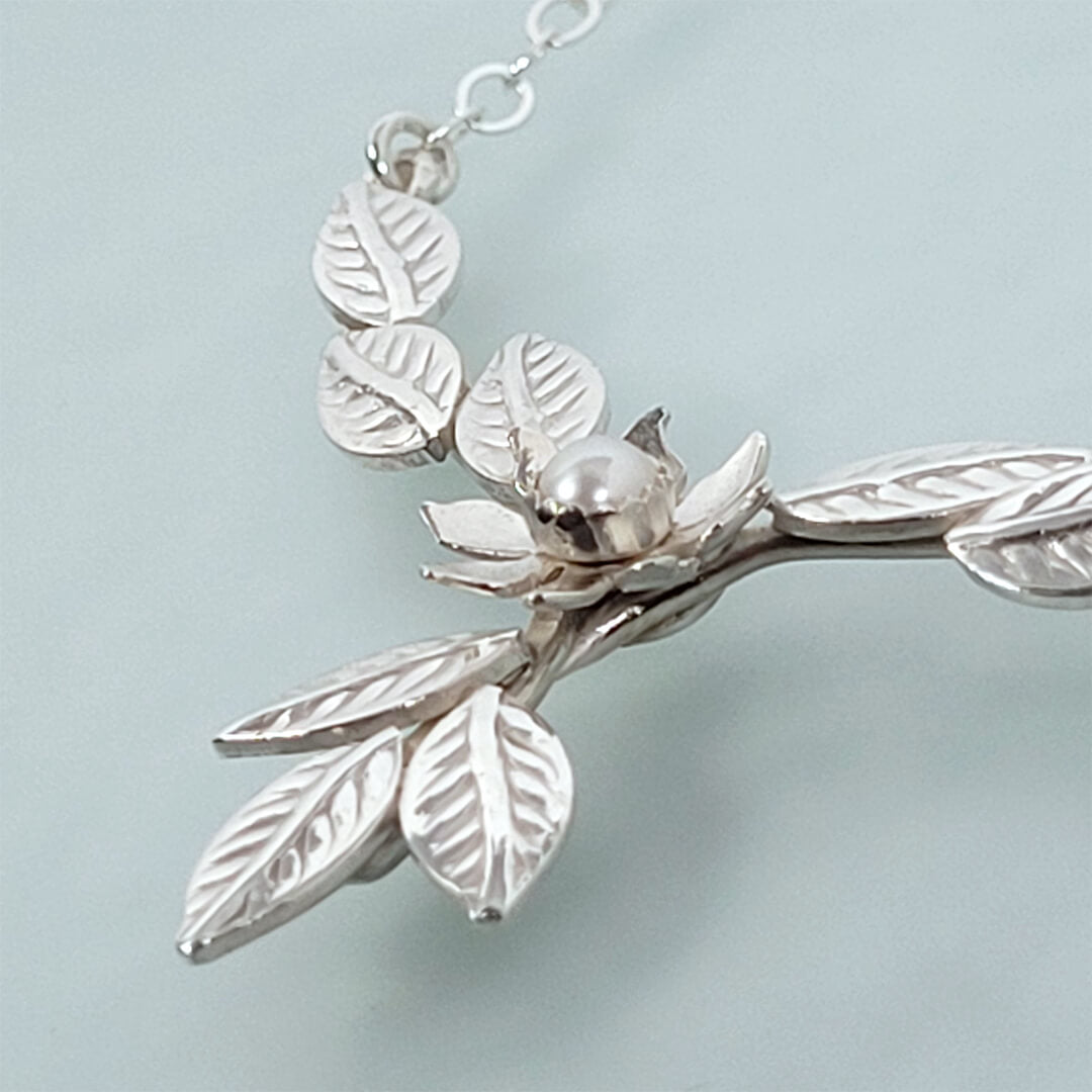 Close-up of flower and leaves necklace 