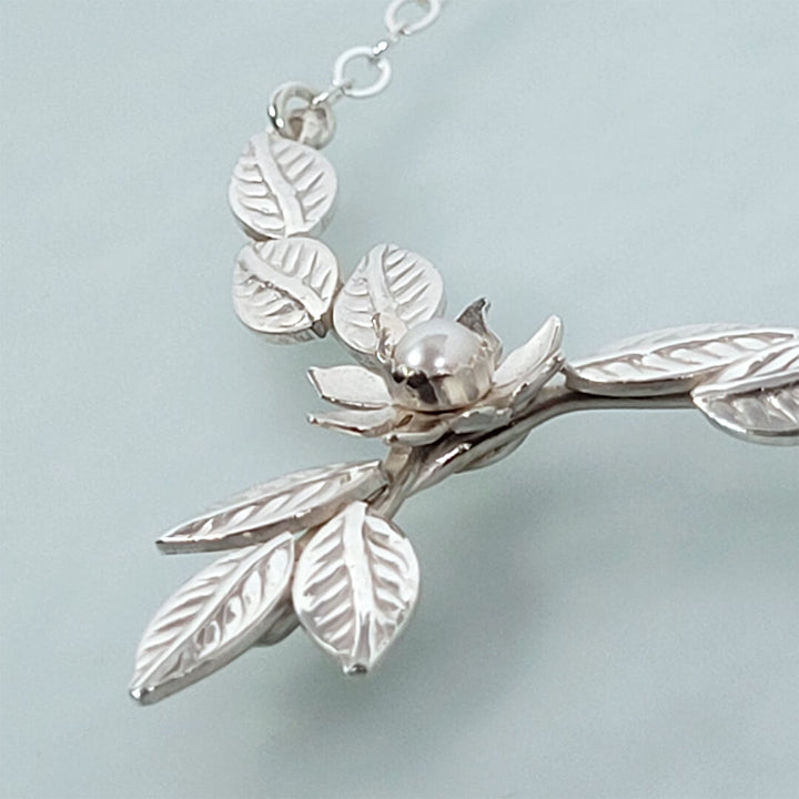 Close-up of flower and leaves necklace 