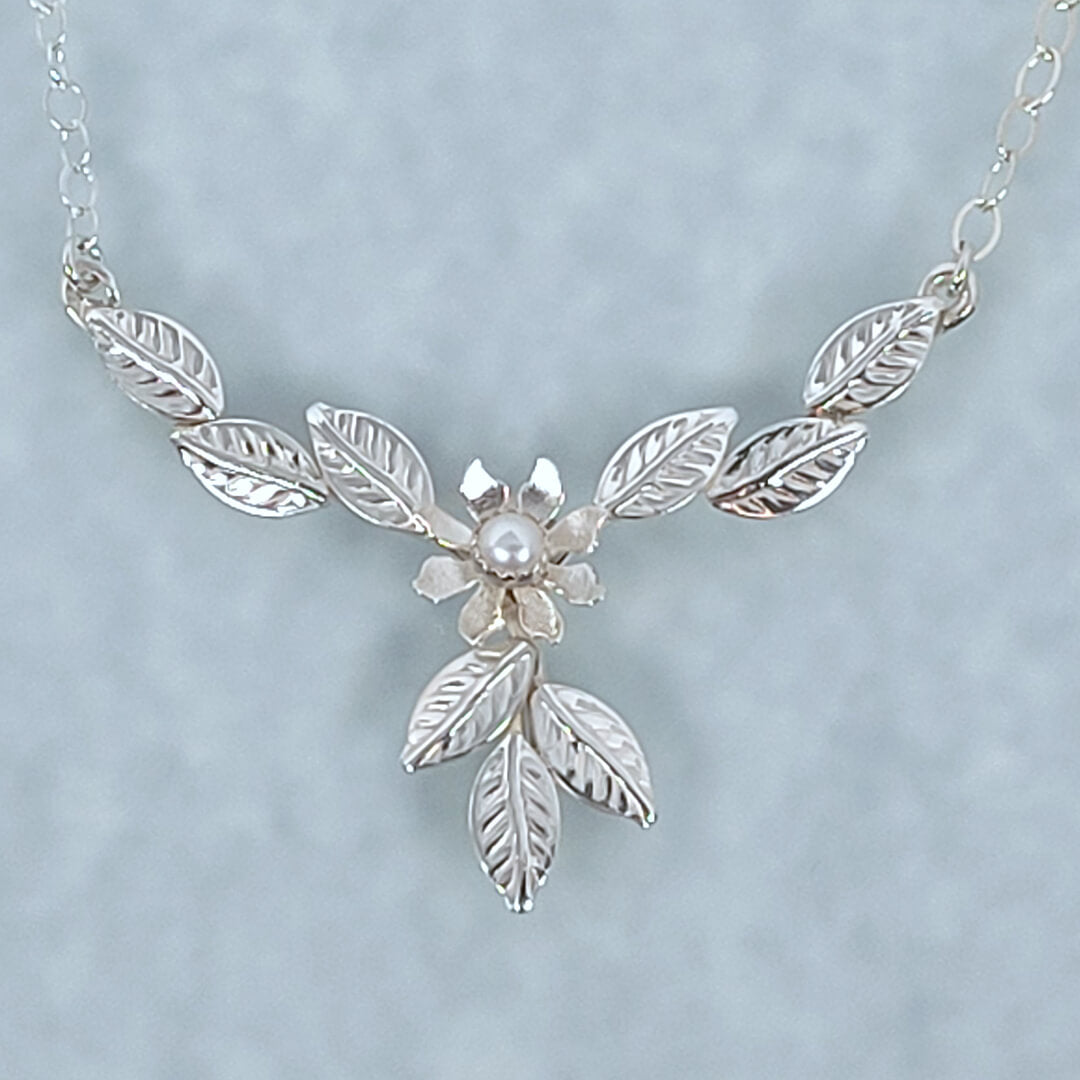 Sterling Silver flower necklace among leaves