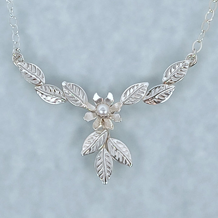 Sterling Silver flower necklace among leaves