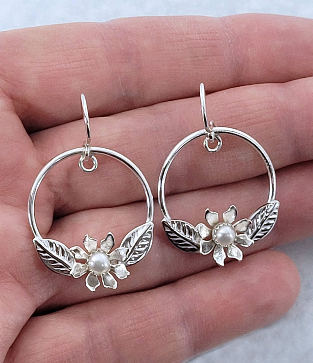 Wild flower hoop earrings in sterling silver with pearls showing size
