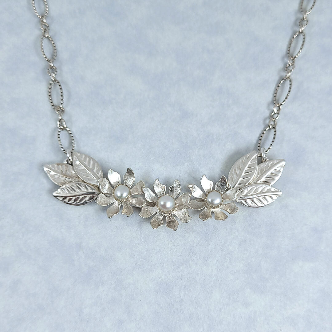 Handmade sterling silver wildflower crescent necklace with cultured freshwater pearls