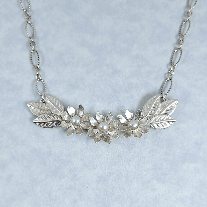 Handmade sterling silver wildflower crescent necklace with cultured freshwater pearls