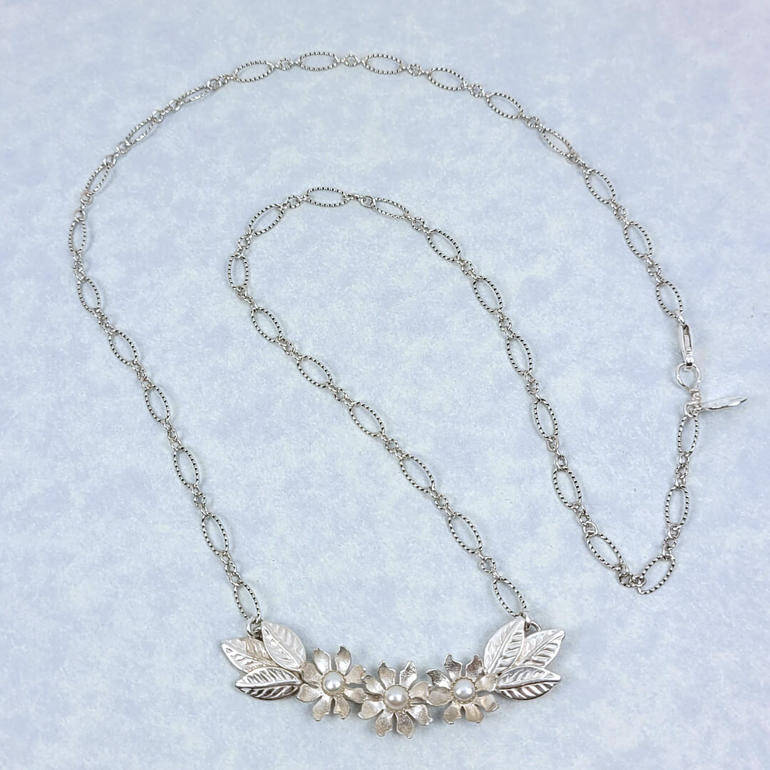 Handmade sterling silver wildflower crescent necklace with cultured freshwater pearls full necklace view