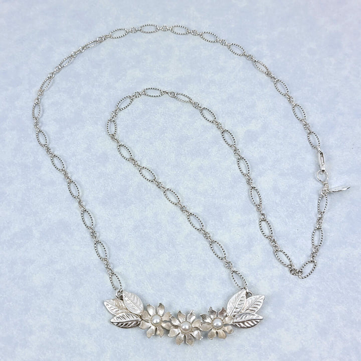 Handmade sterling silver wildflower crescent necklace with cultured freshwater pearls full necklace view