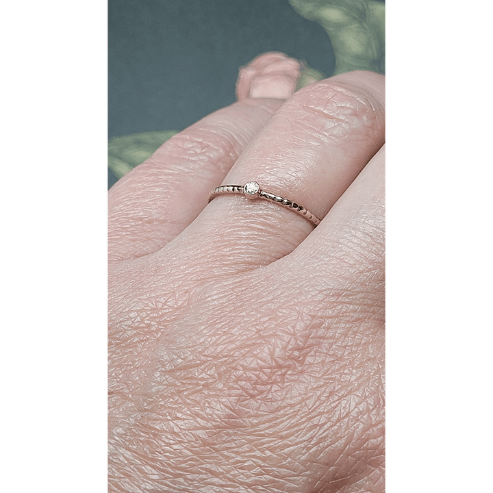 Tiny diamond ring with textured band in 14kt gold
