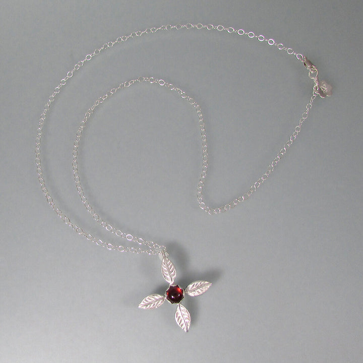 Sterling silver four petal flower necklace with garnet