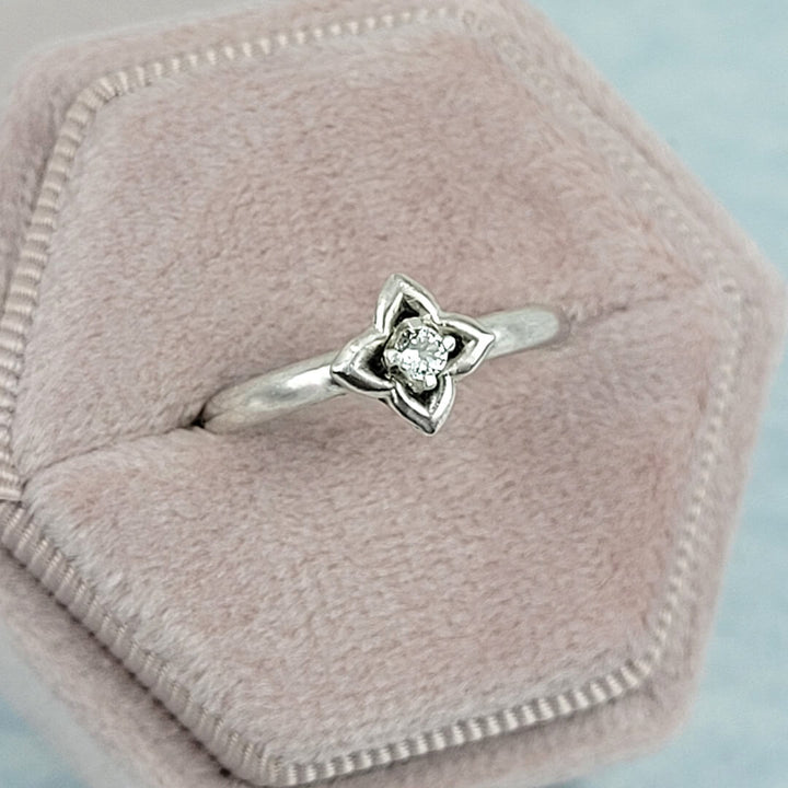 white sapphire ring with clover setting in sterling silver
