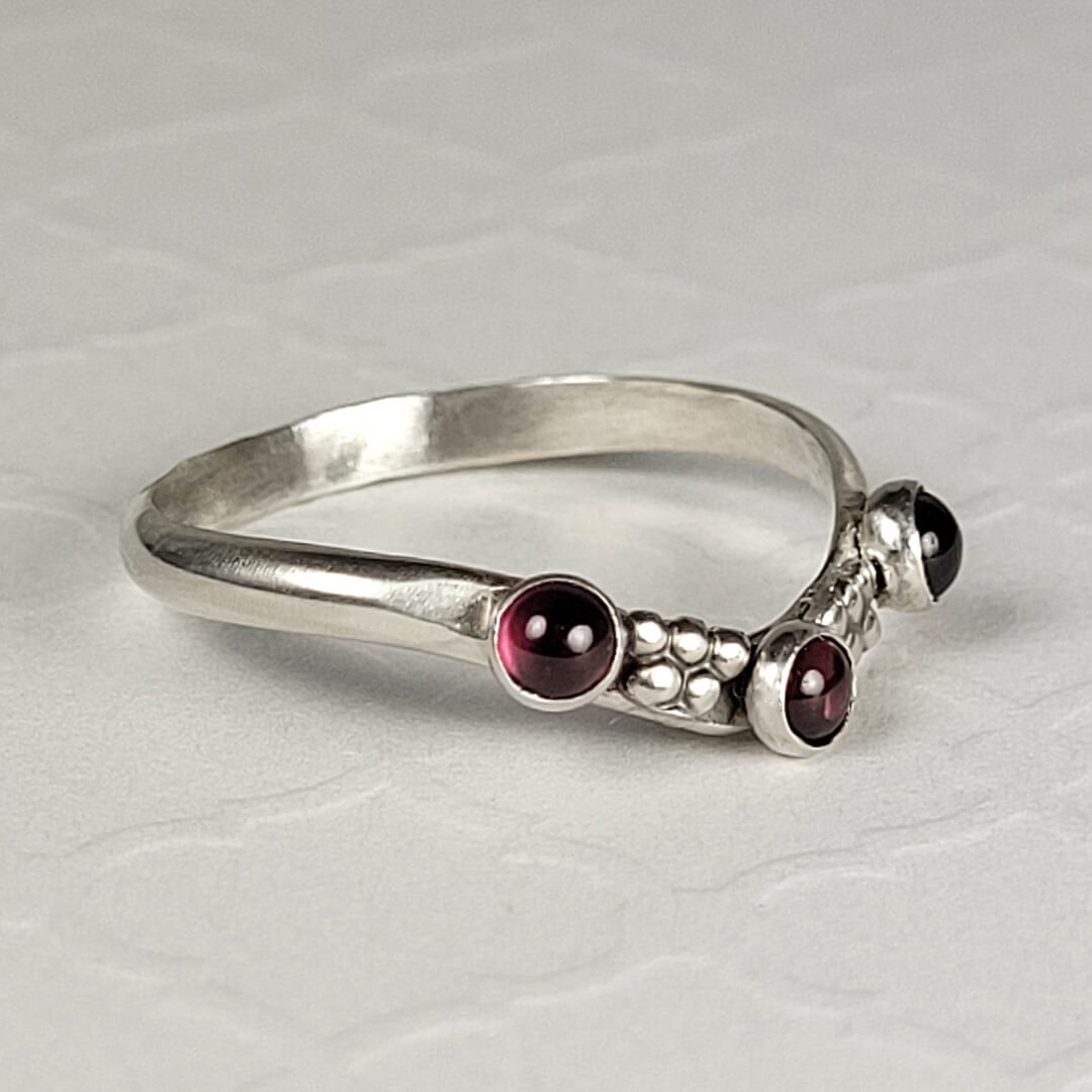 Curved ring band with garnets sterling silver