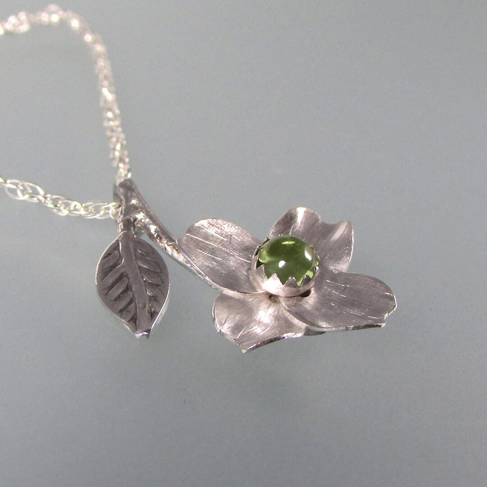 Silver dogwood flower necklace with peridot
