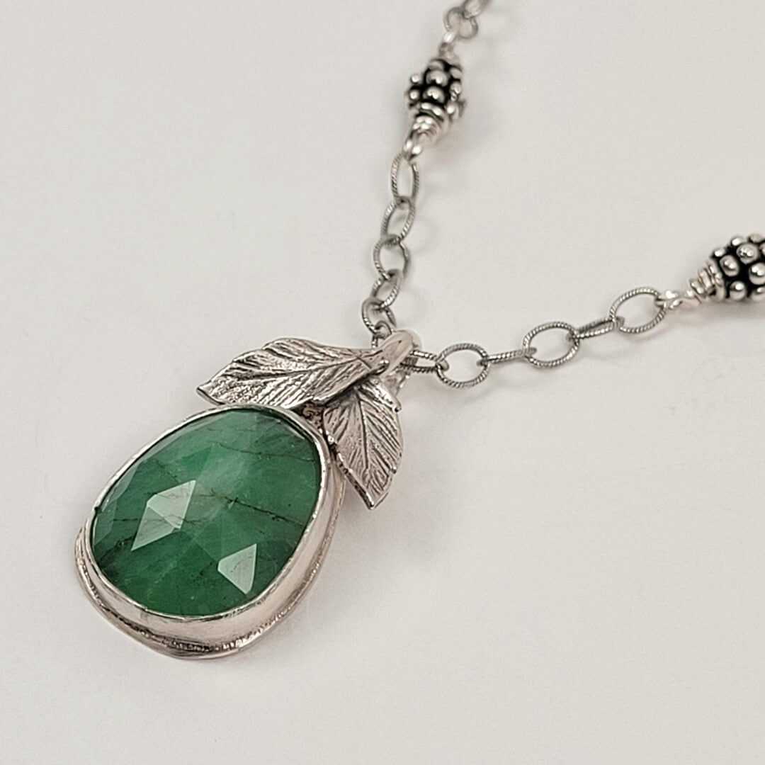 silver faceted raw emerald necklace with leaves