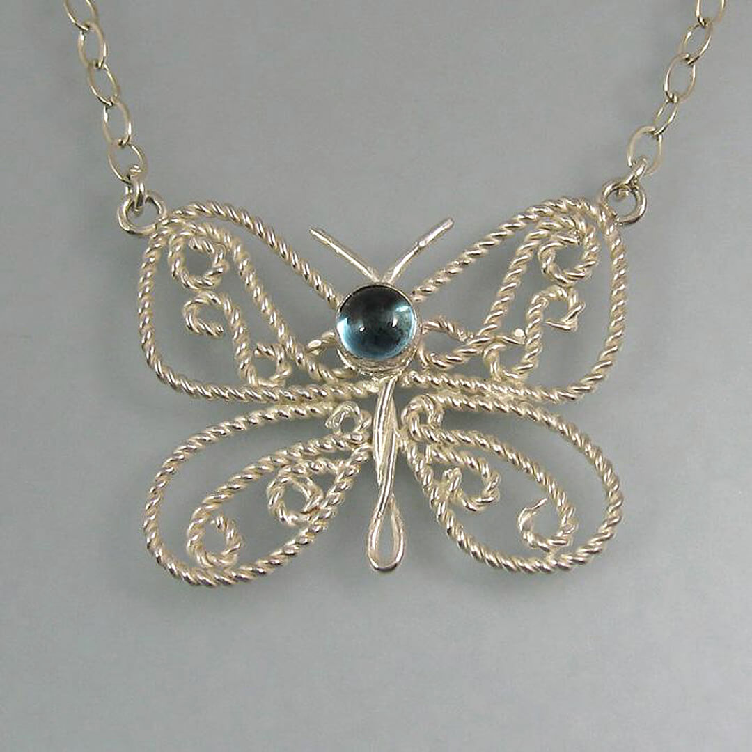 filigree butterfly necklace in sterling silver with blue topaz