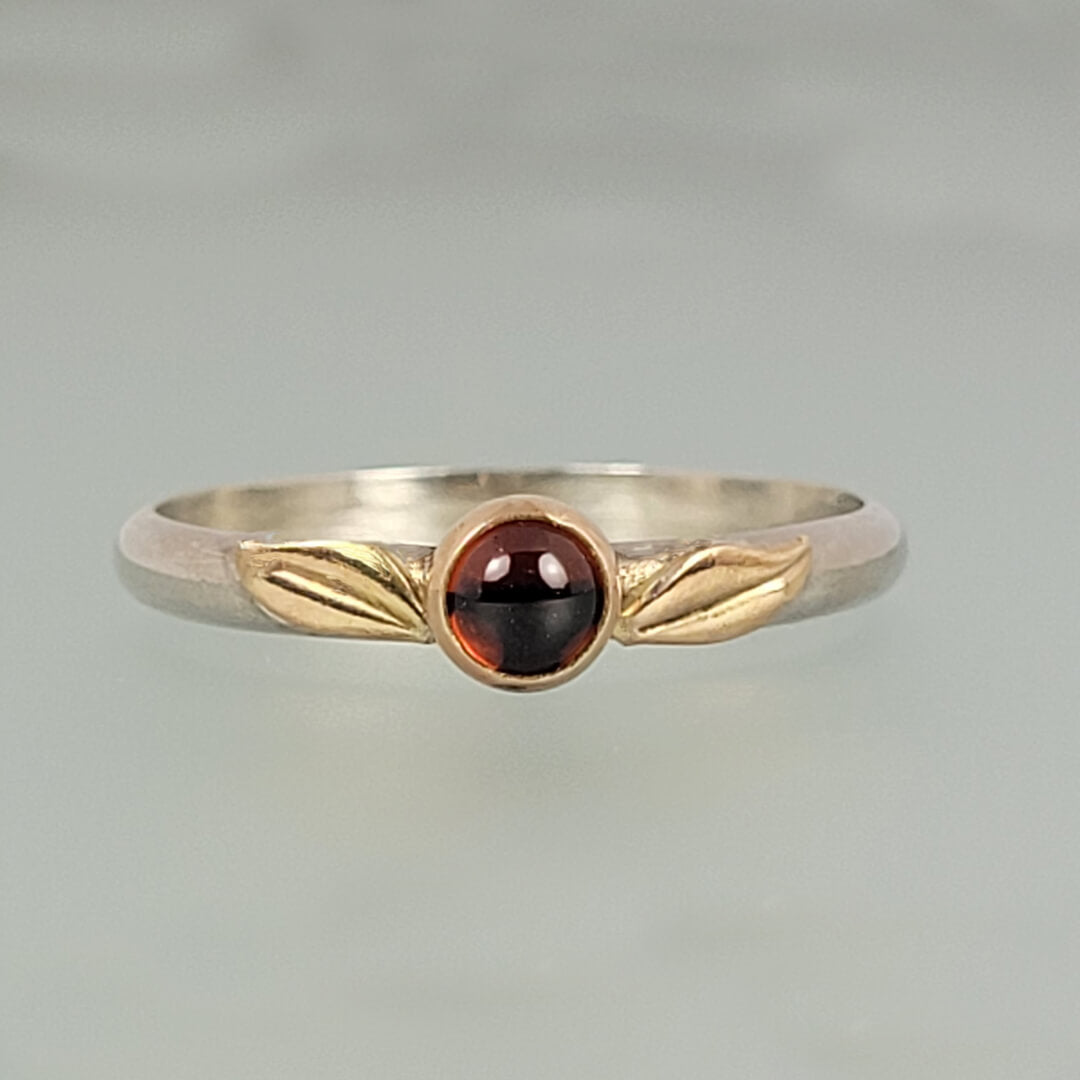 nature-inspired garnet ring with 14kt yellow gold leaves