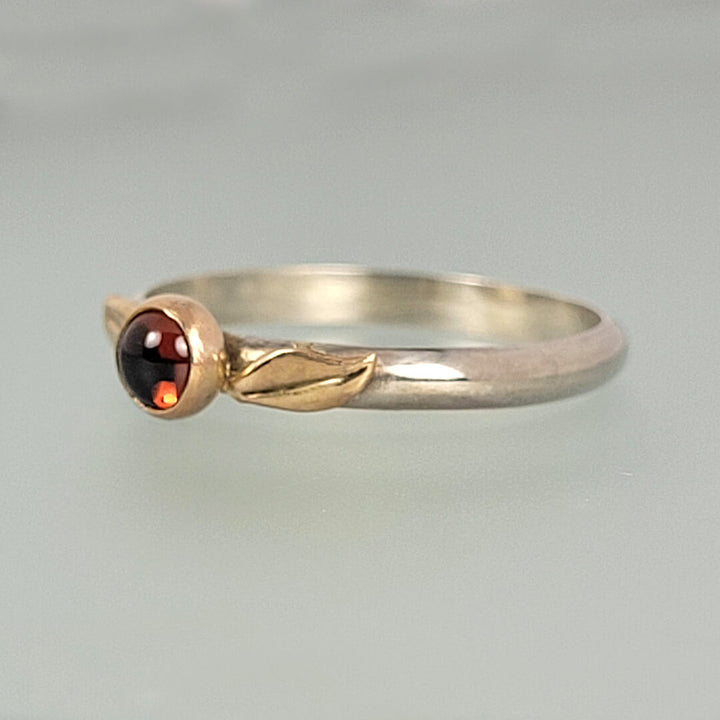 nature-inspired garnet ring with yellow gold leaves