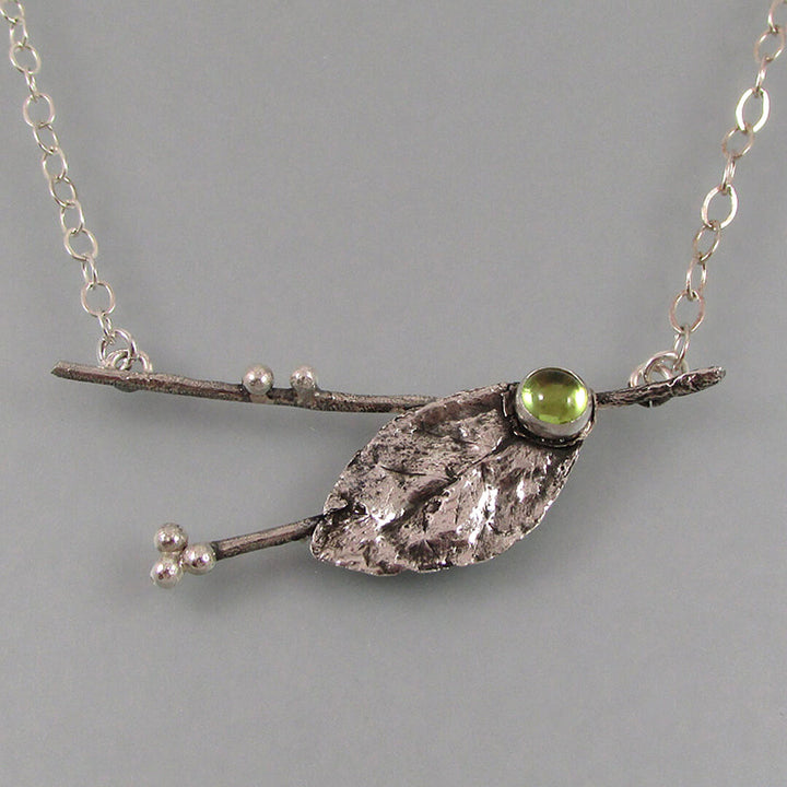 real leaf and branch necklace with peridot