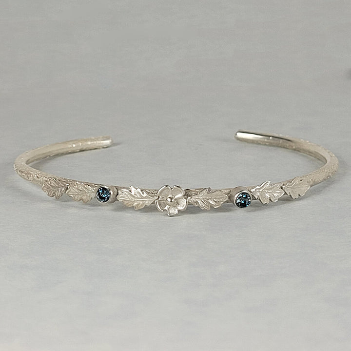 Sterling silver cuff bracelet with London blue topaz, leaves and flower